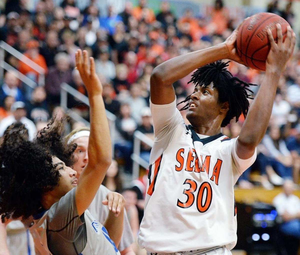 Selma’s Tiveon Stroud, right, eyes a jump shot against a player from Orange Glen-Escondido during their CIF Southern California Regional Division III boys basketball quarterfinal playoff game at Selma High School on Saturday, March 11, 2017.
