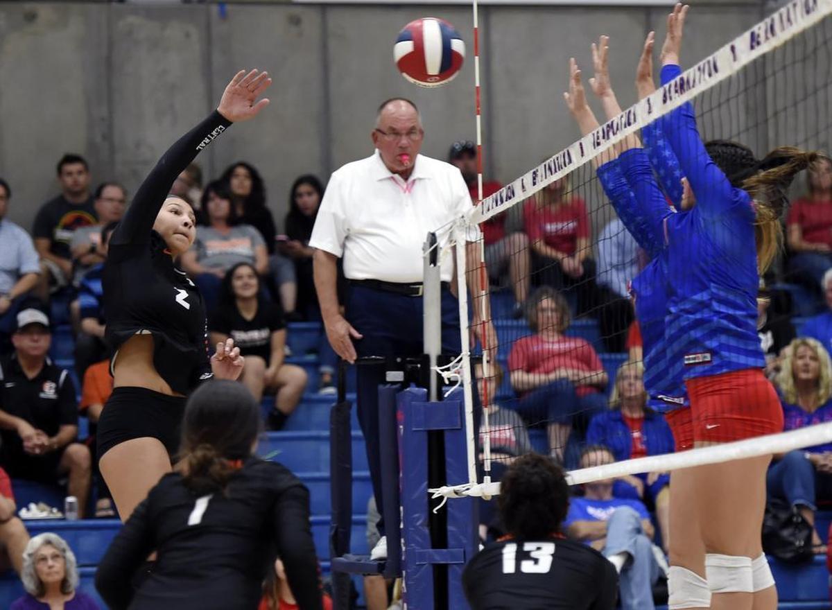 Centrals’ Makayla Lewis, left, slams the ball against BUchanan in a Tri-River Athletic Conference showdown at Buchanan High Tuesday, October 3, 2017 in Clovis, CA. Central won with 3-2 sets.