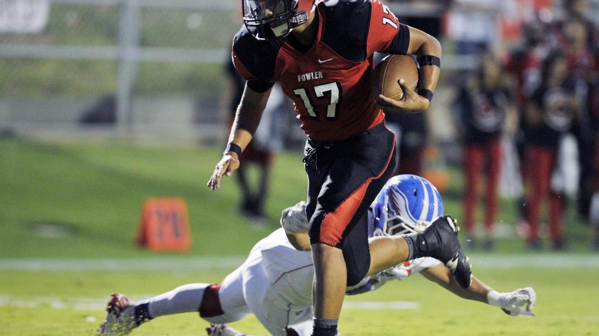
Fowler and Izaiah Moreno – getting past Firebaugh’s Carlos Cortez on his way to a touchdown on Sept. 4, 2015 – will be looking to snap a three-game losing streak against Liberty-Madera Ranchos when the two teams meet Friday, Sept. 18, 2015.
