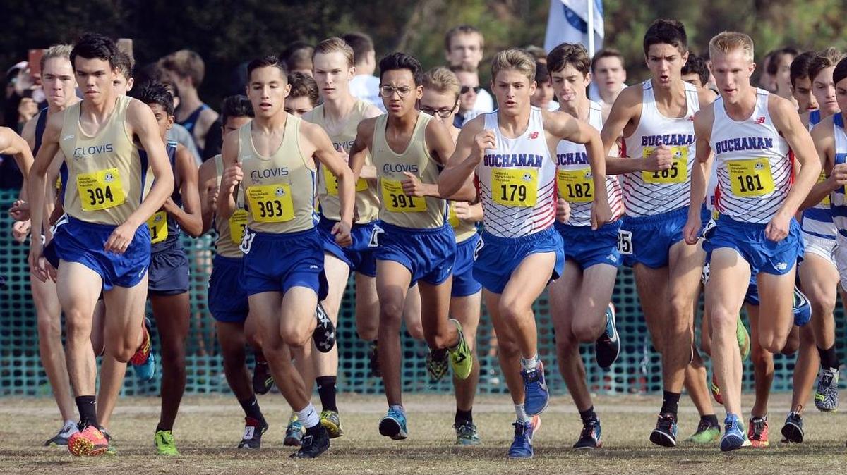 Clovis and Buchanan high runners take off at the start of the Division l race at the 2017 CIF State Cross Country Championships on Saturday, Nov. 25, 2017, at Woodward Park.