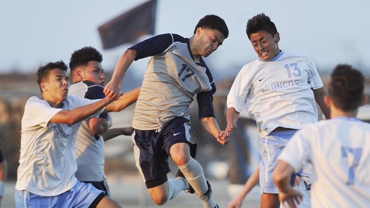 Sunnyside High’s Arturo Ceballos, center, and Clovis North’s Luis Castillo duel for control in Tuesday’s opening round match of the Central Section Division I boys soccer playoffs. The eighth-seeded Broncos beat No. 9 Sunnyside 2-1, earning a shot at top-seeded Buchanan in a Thursday quarterfinal.
