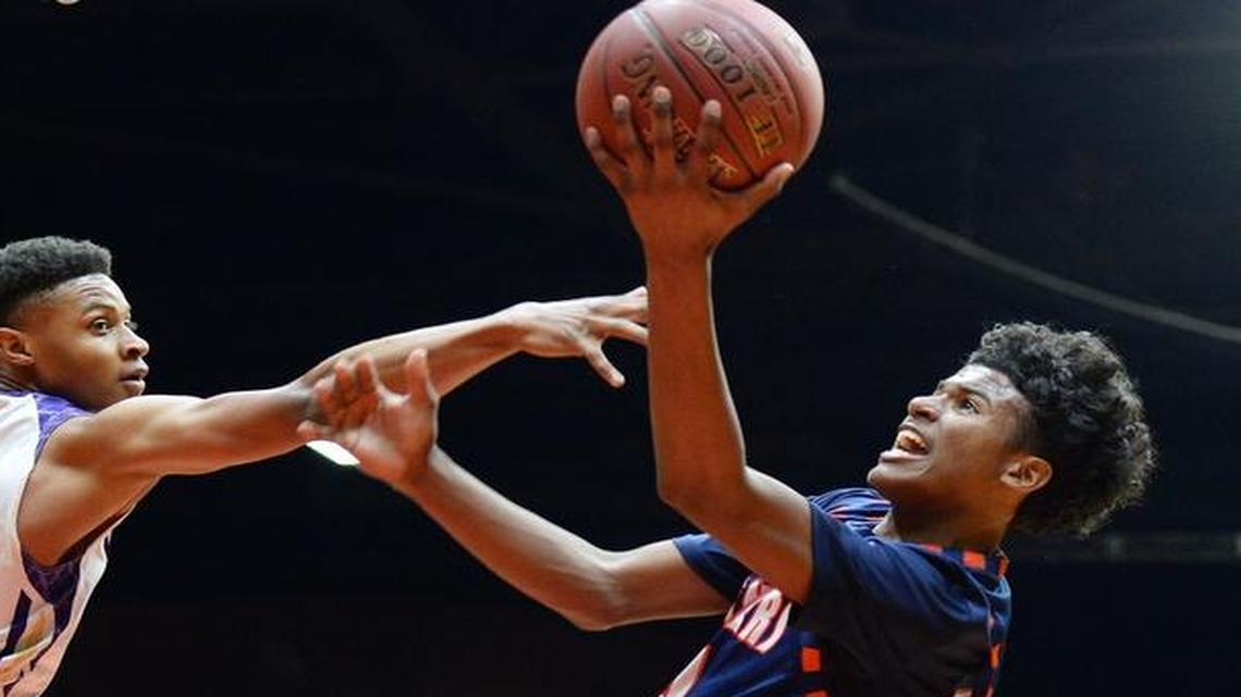 Memorial’s Jalen Green, center, shoots against Ridgeview’s Justin McCall during the Central Section Division II boys basketball championship game at Selland Arena on Friday, March 3, 2017. Green was named to the U.S. Under-16 National team on Tuesday, June 6, 2017.