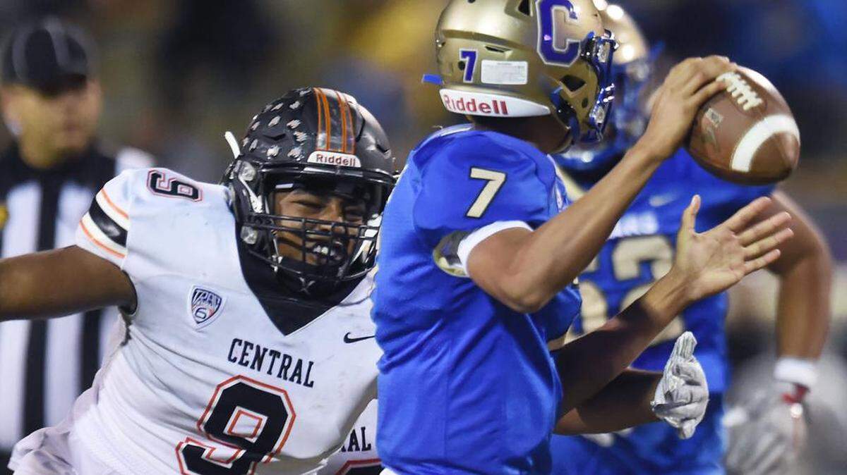 Central High’s Cameron Vaughan, left, sacks Clovis High quarterback Isaiah R. Robles, right, in a matchup Thursday night, Oct. 9, 2019 in Clovis. Central beat Clovis High 56-14 at Lamonica Stadium.