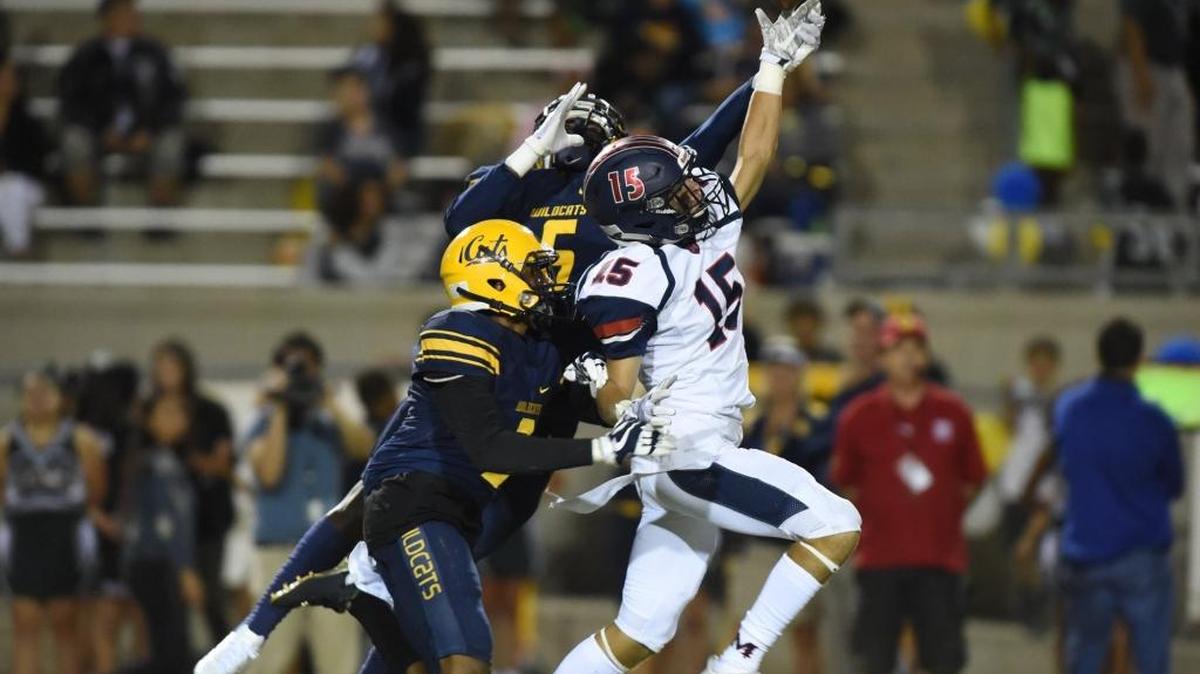 Sunnyside defenders Kiundre McDowell, front left, with Cameron Irvin, back, break up a pass intended for San Joaquin Memorial’s Mac Dalena in the first quarter of Friday’s game.