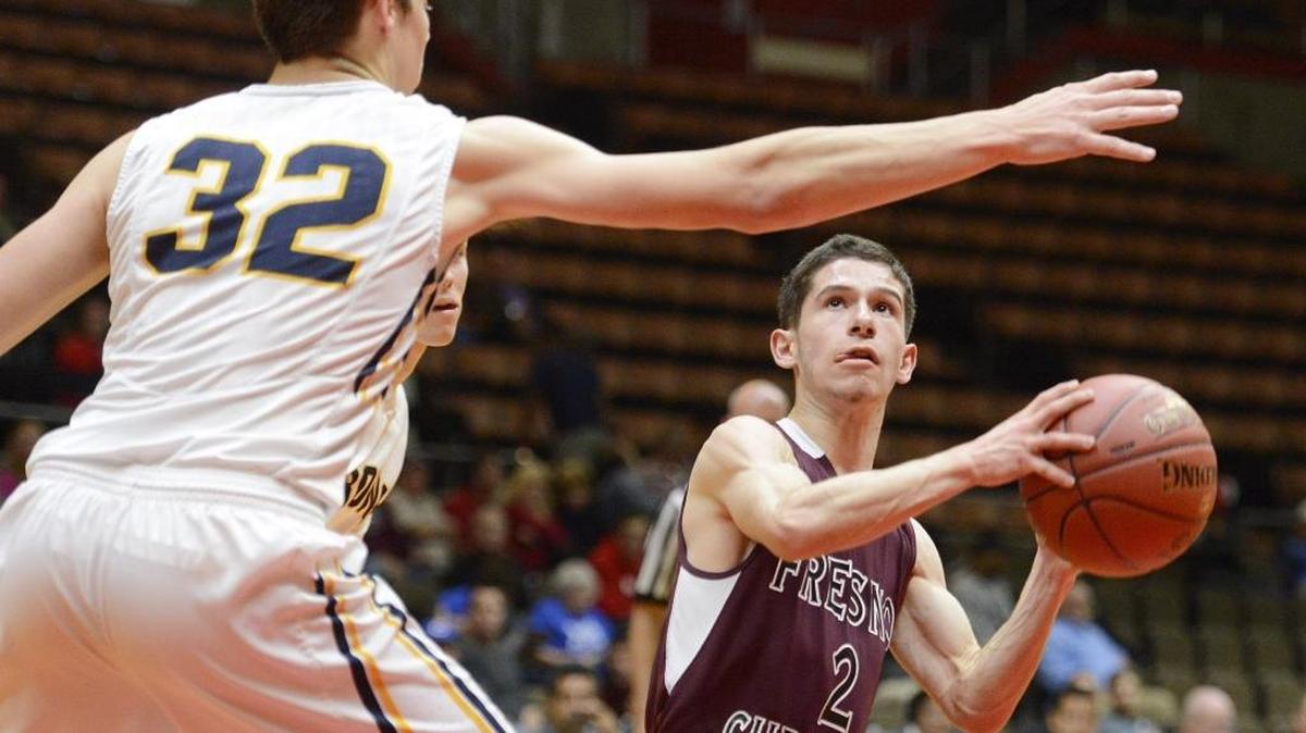 Fresno Christian High’s Trevor Trevion eyes the hoop while being defended by Kern Valley’s Austin Hurley in their Central Section Division V championship game Friday at Selland Arena. Trevion and his 14th-seeded Eagles teammates fell just short of arguably the biggest upset in the history of the Selland championships, losing to the top-seeded Broncs 57-54.