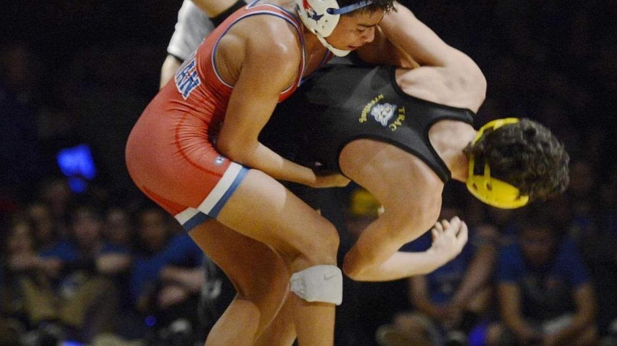 Buchanan High’s Matt Olguin, left, works to take down Clovis’ Brandon Betancourt in the 106-pound match of their Tri-River Athletic Conference dual Thursday night. Olguin, a freshman, provided the clinching points with his 7-5 victory as the Bears snapped the five-time reigning state champion’s streak of 91 consecutive dual wins against California opposition with a 32-27 win in a matchup of the state’s No. 1- and No. 2-ranked teams.
