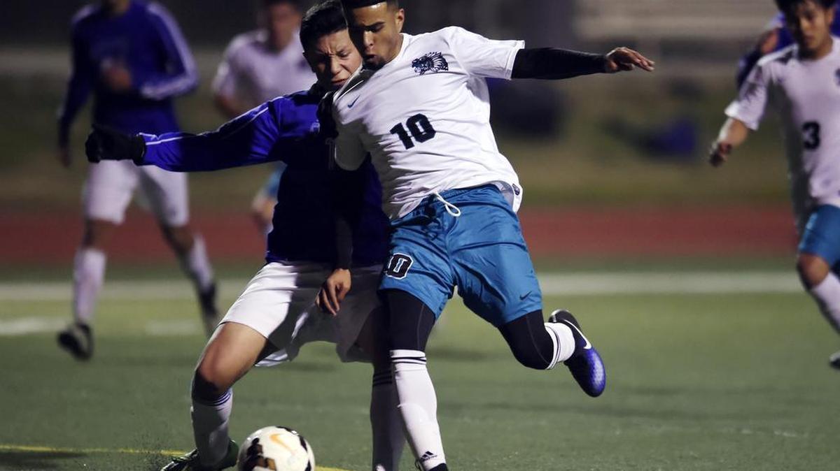 Mendota’s Daniel Trejo, right, drives past Avenal’s Francisco Rosario, left, Tuesday, Jan. 17, 2017 in Mendota, Calif.