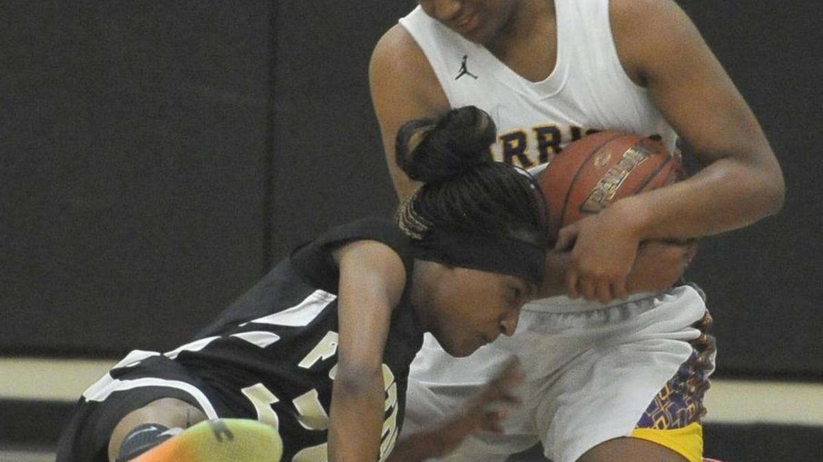 Fresno High's Destiny Robinson, top, wrestles the ball from Foothill's Tyquisha McFadden during Wednesday night’s playoff game at Fresno High.