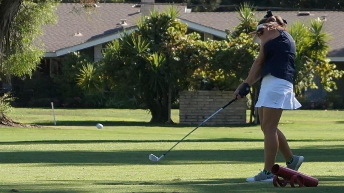 Clovis East High golfer Morgan Polley hits her drive Monday on No. 11 at Fort Washington Country Club. She used a 6-iron to ace the 138-yard hole.