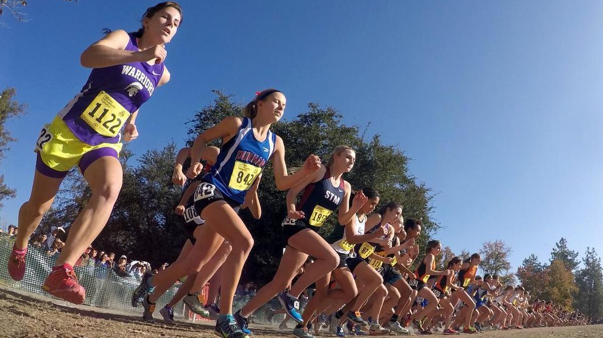 Runners take off at the start of the girls Division V race during the CIF State Cross Country Championships at Woodward Park on Nov. 29, 2014. The state meet will continue to be held in Fresno through 2021, the CIF announced Friday, Nov. 27, 2015.