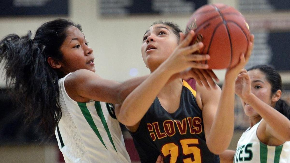 Clovis West High freshman Justyce Harris absorbs a foul by Garces’ Anela Irven during their game at the Central Valley Showdown tournament Thursday, Nov. 30, 2017.