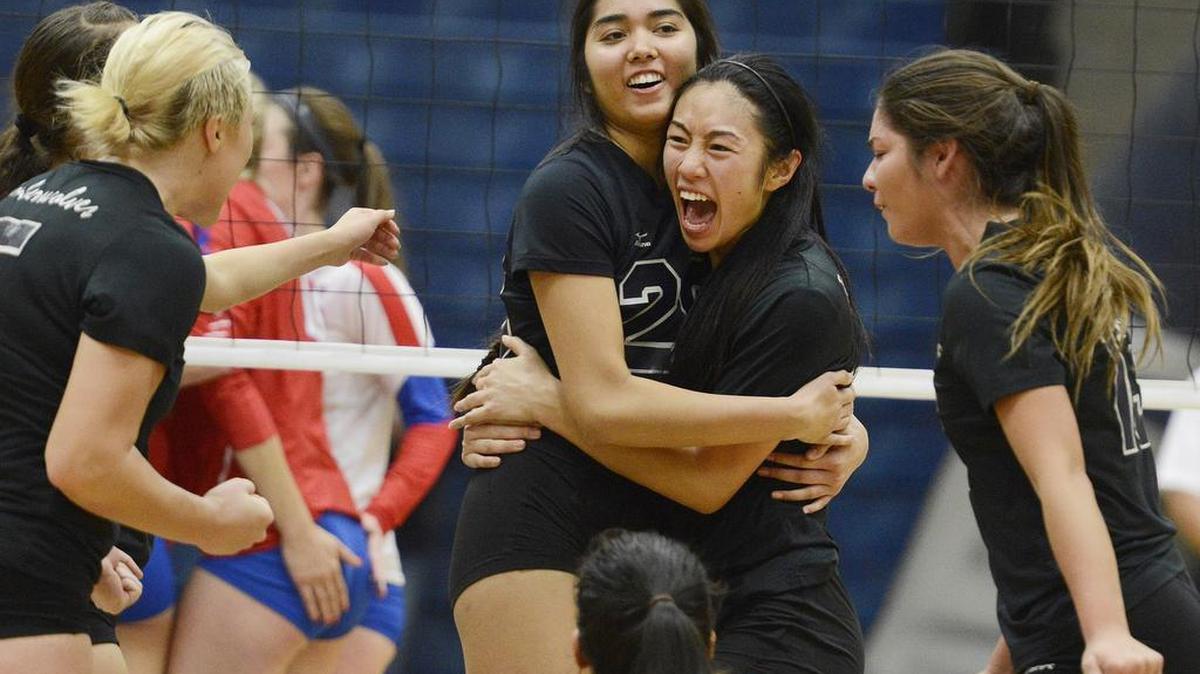 Clovis East's Thaliana Grajeda, center left, and Christina Tran celebrate a point with teammates against Buchanan in their Central Section Division I quarterfinal match at Clovis East Thursday, Nov. 12, 2015. Clovis East won the 3-2.