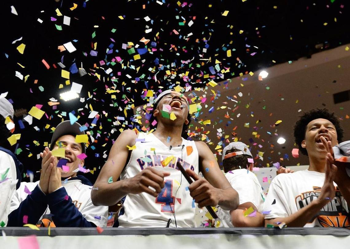 Memorial's Jalen Green, center, celebrates with teammates after the Panthers defeated Selma in their boys Division II CIF Central Section championship basketball game at Selland Arena in Fresno on Friday, March 2, 2018.