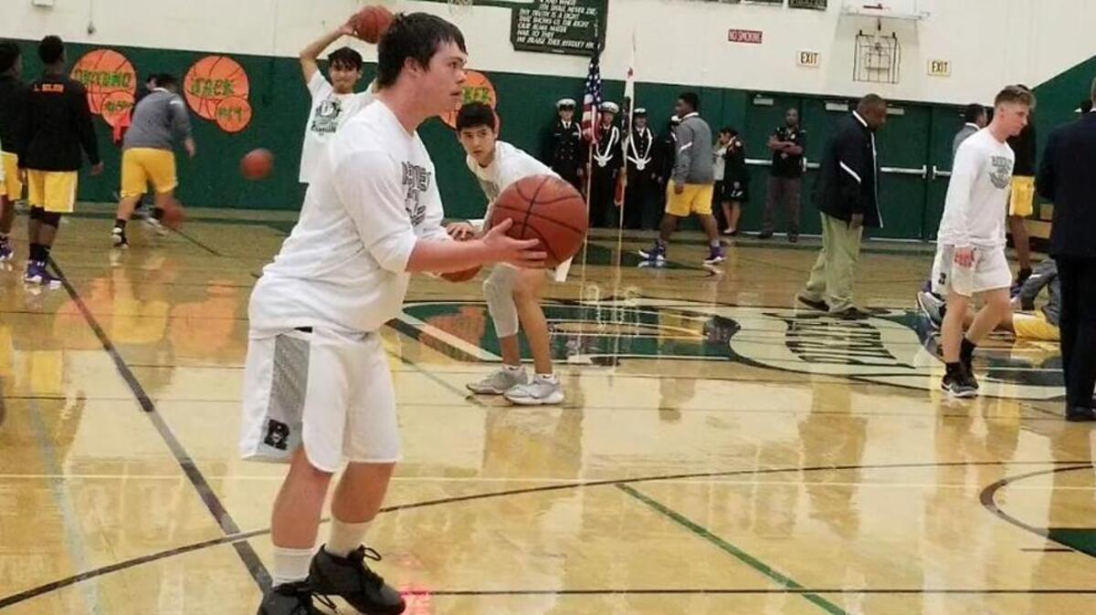 Reedley High team manager Jack Welsh warms up before the Pirates’ game against Fresno on Thursday, Feb. 8, 2018.