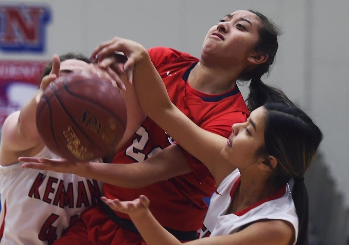 Sanger High’s Anelise Lopez, left, and Kerman’s Jocelyn Gong fight for the rebound at the Old Town Clovis Kiwanis New Year’s Eve Classic on Saturday, Dec. 30, 2017. Lopez scored 21 points and Stephanie Herring added 16 in a 59-55 championship game win.