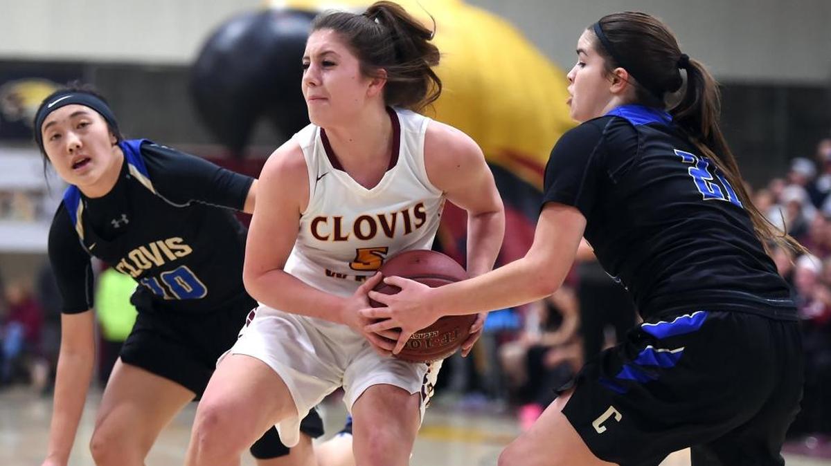 Clovis West High’s Sarah Bates takes on Clovis’ Jasmine Heu, left, and Taylor Correa in a Tri-River Athletic Conference game Friday, Jan., 27, 2017. Bates had nine rebounds, seven points and three steals as the Golden Eagles won 73-30 in a matchup of teams that entered ranked Nos. 1 and 2 in the Central Section by The Bee. Clovis West also stands prominently in national rankings by USA Today and MaxPreps.com.