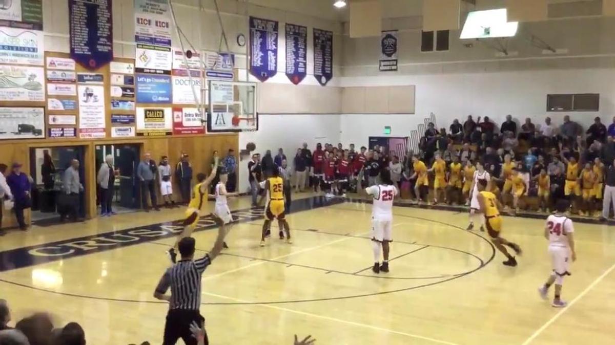 Clovis West High’s Cole Anderson, in gold to the left of the backboard, begins to celebrate after hitting what was ruled to be a buzzer-beating basket to advance the Golden Eagles to the semifinals of the 18th annual Modesto Christian Holiday Hoop Classic on Thursday, Dec. 28, 2017.
