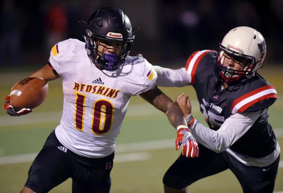 Tulare Union running back Kazmeir Allen cuts around Tulare Western’s Julian Trevino in the Bell Game on Nov. 3. Both teams are in action Friday in a Central Section playoff doubleheader at Bob Mathias Staidum.