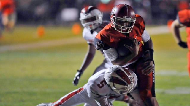 Chowchilla’s David Tapia, left, cuts Kerman’s Sean Chambers’ run short of the goal line Friday night, Oct. 9, 2015 in Kerman.