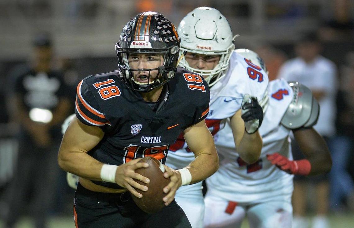 Central quarterback Trent Tompkins, left, takes off down field on a keeper while being chased down by the Buchanan defense in their game at Koligian Stadium on Friday, Sept. 28, 2018.