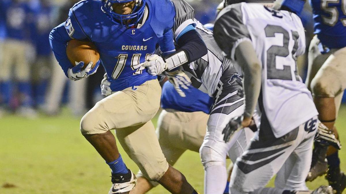 
Clovis' Samir Allen, left, peels away from a Clovis East tackle on a run in the first half of their first-round Division I playoff game at Lamonica Stadium Nov. 14, 2014. The junior’s been out with a broken leg for The Bee’s No. 1 Cougars after being named All-Tri-River Athletic Conference last year.
