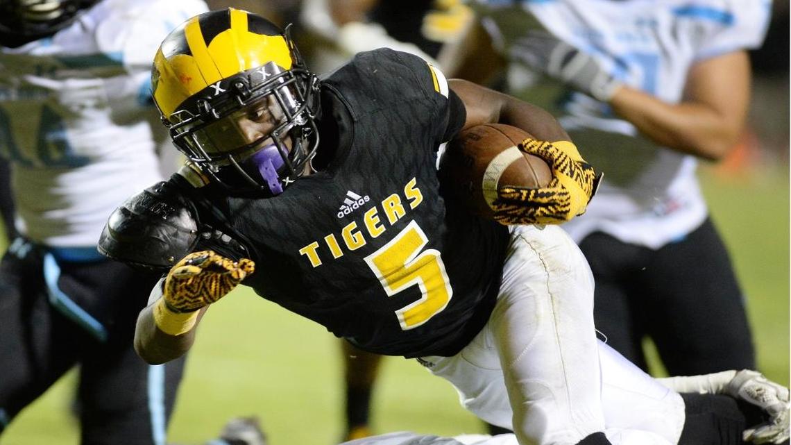 Edison’s Mckinley Lee III lunges forward for extra yards on a carry against Clovis North during their game at McLane on Sept. 15, 2017.