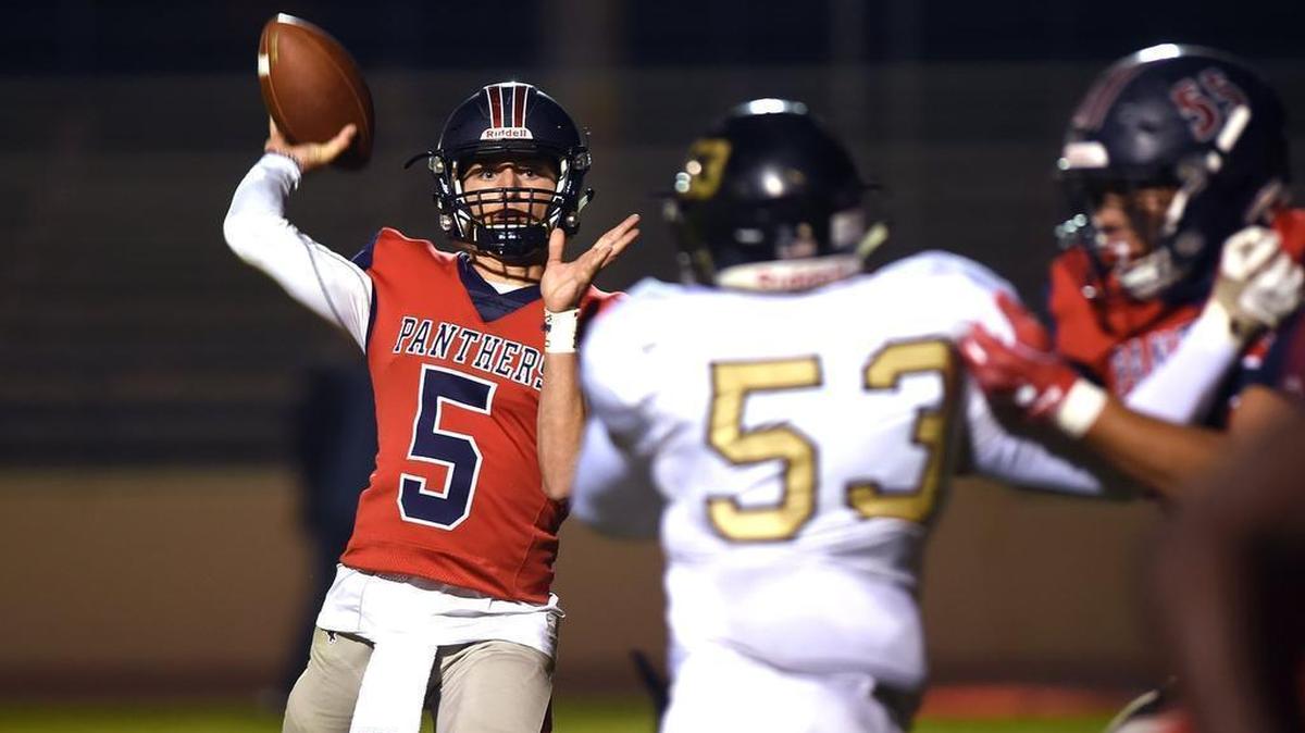 San Joaquin Memorial quarterback Alec Trujillo, left, passes against San Luis Obispo in the Central Section D-III playoffs Friday night, Nov. 9, 2018 in Fresno. San Joaquin Memorial led 57-3 at halftime.