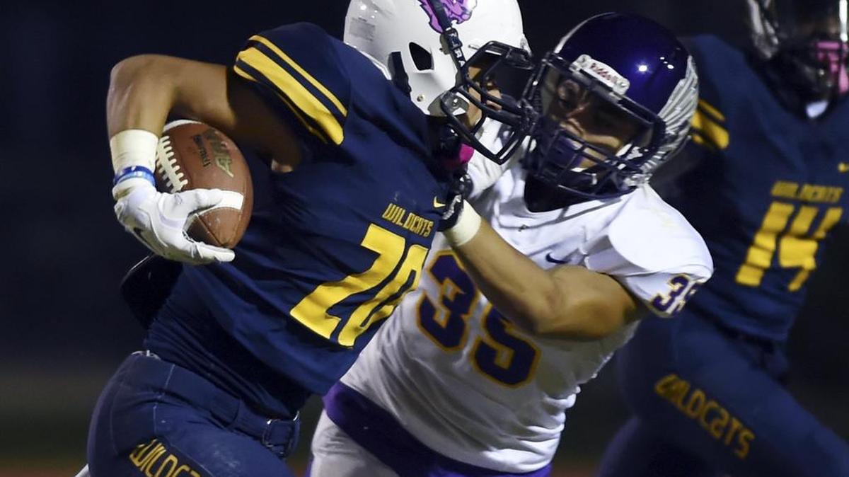 Sunnyside’s Ricky Valderrama, left, carries the ball with Fresno High’s Jayvon Bishop to the right on Oct. 21, 2016 in Fresno, Calif. Valederrama has rushed for over 1,000 yards for the 9-2 Wildcats as they head into a D-II semifinal game at Sanger on Friday night.