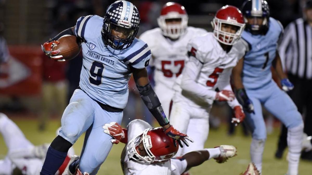 Bullard High’s Marcus Fulcher dodges Sanger’s Morice Norris in a Central Section Division I playoff game Thursday, Nov. 9, 2017.