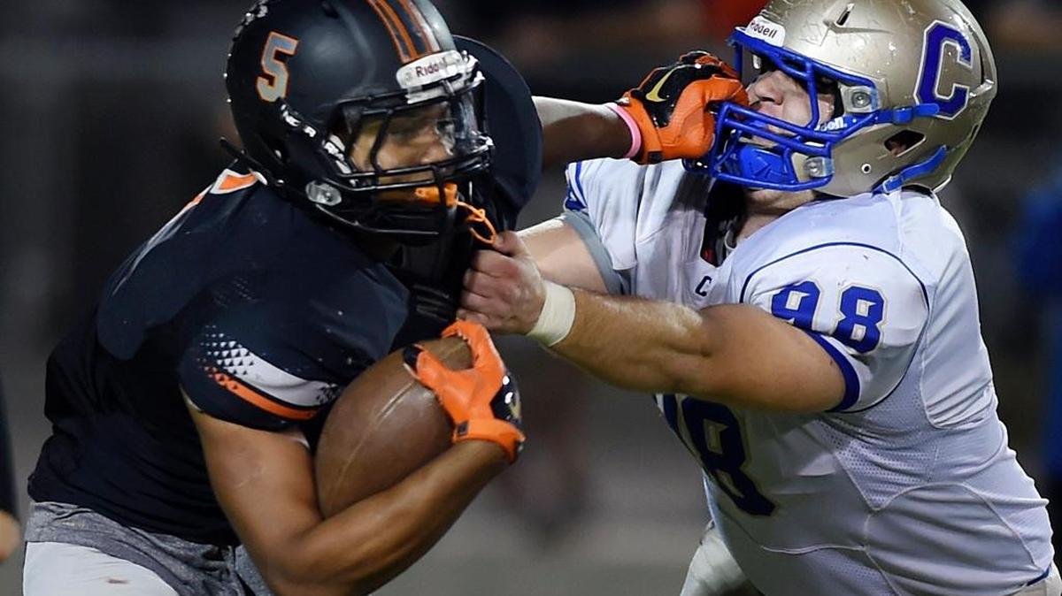 Push comes to shove for Clovis High’s Spencer Smith, right, and the rest of the Cougars on the final Friday of the 2016 Central Section regular season. Clovis’ finale against Clovis West likely lands at least a top-four playoff seed for the winner.