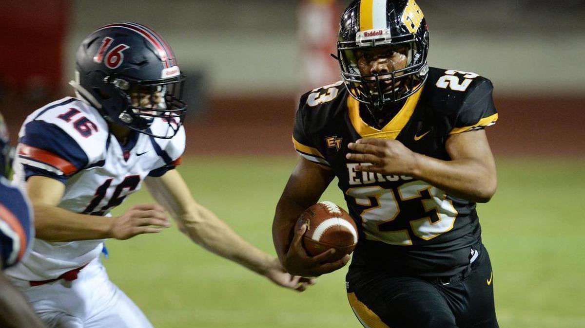 Edison running back Amos Scott, right, skirts by Memorial’s Vincent Rangel on a run play during their game at Ratcliffe Stadium in Fresno on Friday, Oct. 12, 2018. Both teams are in action Friday, Oct. 19.