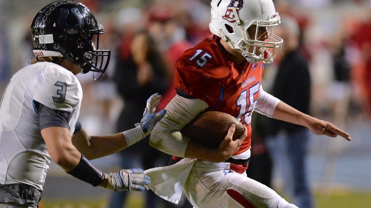 Buchanan’s Nolan LeForge runs the ball in for a touchdown past Clovis North’s Chase Maurer in the first half on Nov. 6, 2015, at Veteran’s Memorial Stadium in Clovis, California