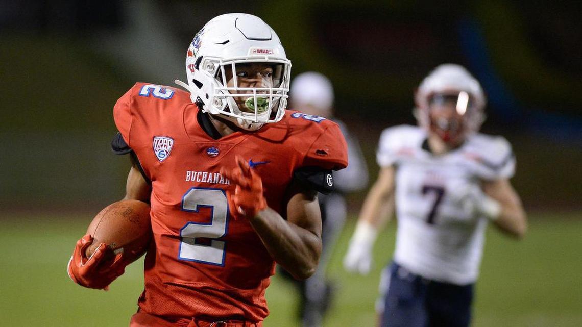 Buchanan’s Kendall Milton charges down the sidelines for a 49 yard touchdown against Liberty-Bakersfield during a Division I semifinal game at Veterans Memorial Stadium in Clovis on Friday, Nov. 22, 2019.