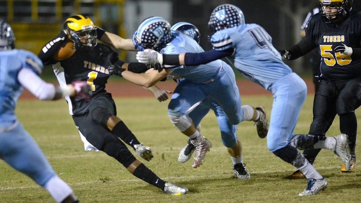 
Bullard linebacker Ben Baker, shown second from right in taking on Edison quarterback A.J. Greeley last year, was outstanding in a 21-14 loss at state-ranked Grant-Sacramento on Saturday night. Baker was a Bee All-Star as a sophomore in 2014. 
