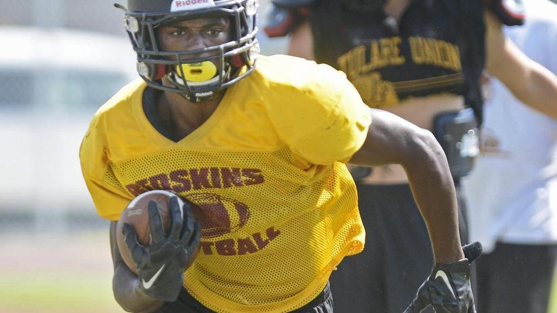 
Tulare High senior Romello Harris takes the ball on a run play during practice with the football team Tuesday. Harris is drawing recruiting interest all over the county, and the stakes could rise with a strong early season showing, as USC and Florida have expressed interest in the nearly 4.0 GPA student.
