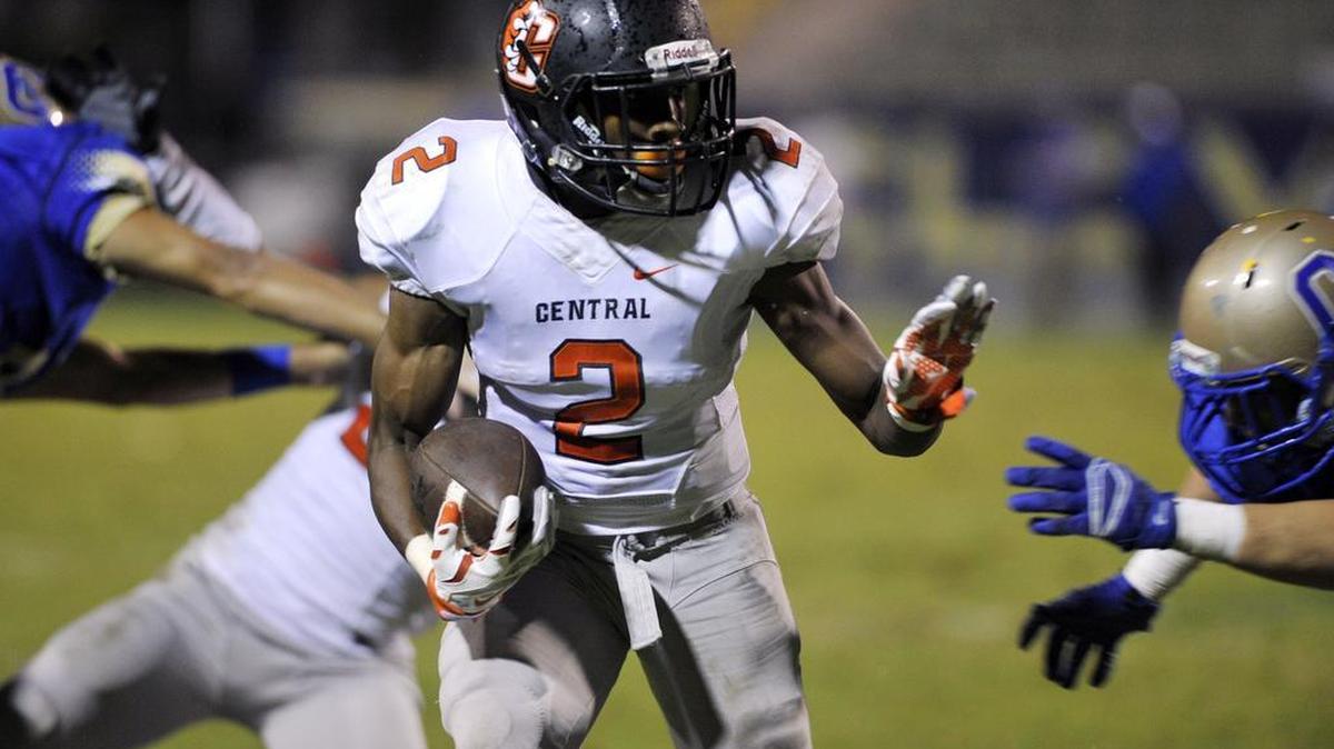 
Central High’s Malik White carries the ball in second-half action of Thursday’s game against Clovis. White and the Grizzlies led the Central Section top-ranked Cougars 21-12 in a game suspended by lightning with 6 minutes to play. The game will be resumed at 10:30 a.m. Saturday at Lamonica Stadium.
