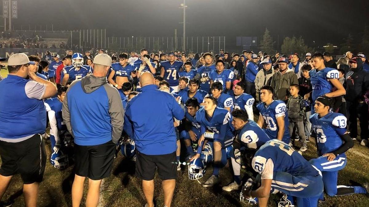 Caruthers High coaches address the team after Friday’s Central Section Division V semifinal victory over Yosemite.