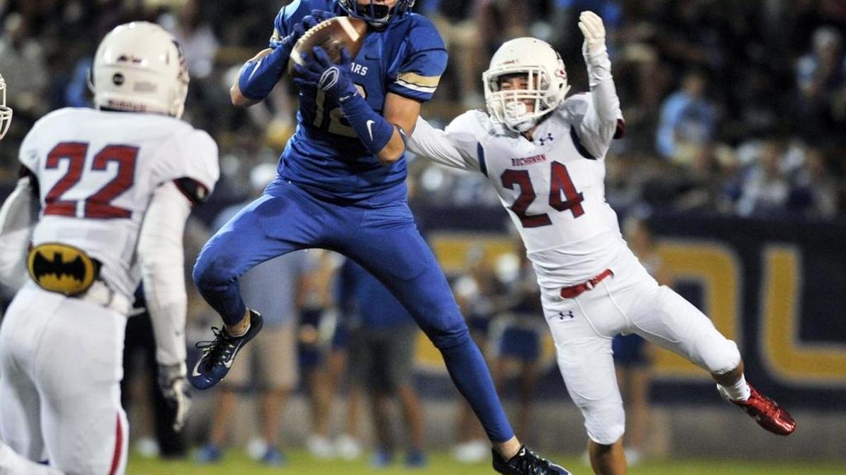 Clovis High’s Coltin Velasquez makes the catch with Buchanan’s Braylen Williams, left, and Keaton Gleason closing in during the teams’ Tri-River Athletic Conference game Oct. 23, 2015. The No. 4 Cougars looked to bounce back after falling out of the No. 1 spot in The Bee’s Central Section rankings with last week’s loss to Central. Buchanan is ranked No. 6.