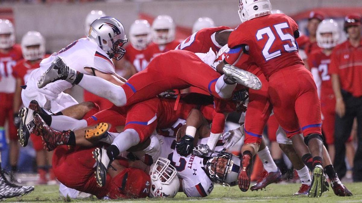 
Liberty High’s Quincy Jountti is stopped by a host of Buchanan defenders in the first half at Veterans Memorial Stadium on Friday, Sept. 18, 2015.
