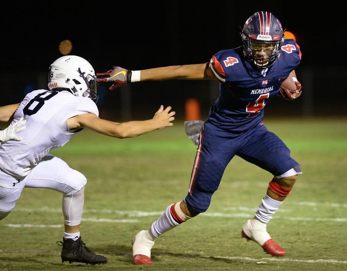 Memorial’s Jalen McMillan, right, turns the corner against Clovis East’s Chandler Hamilton during their 2018 matchup.