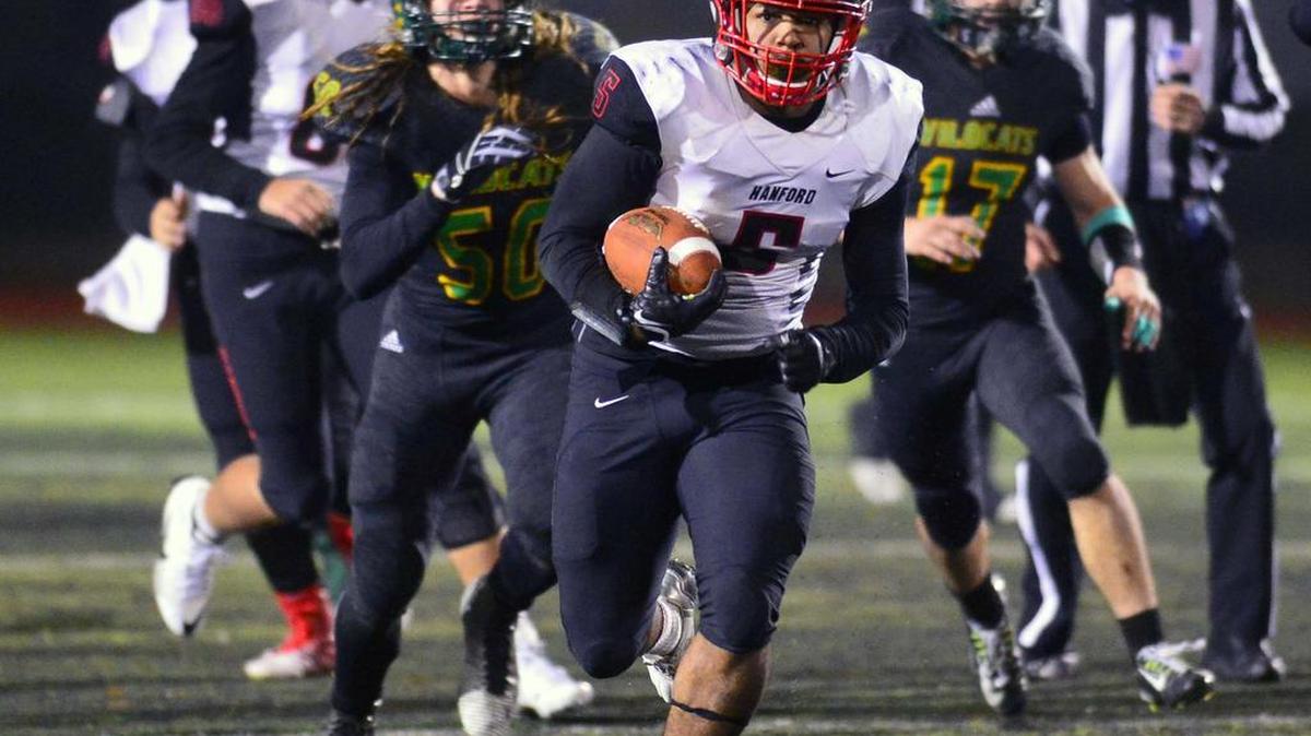 Hanford running back Joseph McDaniel (5) breaks away from the Sonora defense during a CIF Regional Football Championship IV-AA Bowl Game where Hanford defeated Sonora 42-18 at Sonora High School in Sonora California on December 11, 2015.