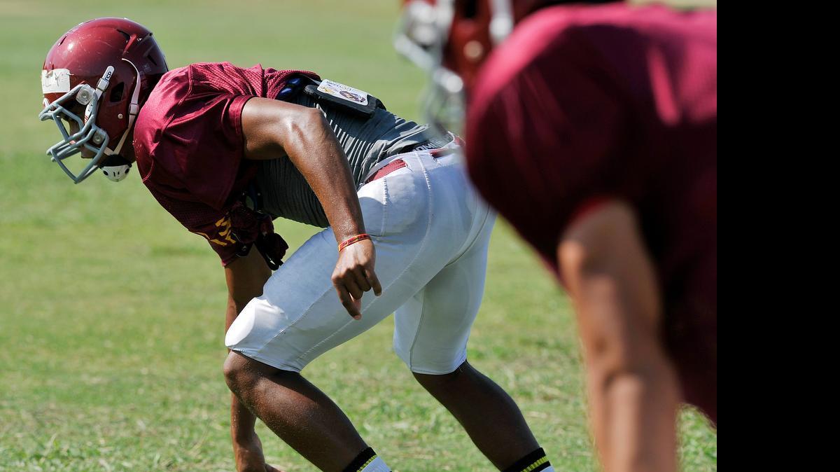 
Clovis West High’s Caleb Kelly lines up during a 2014 preseason workout.
