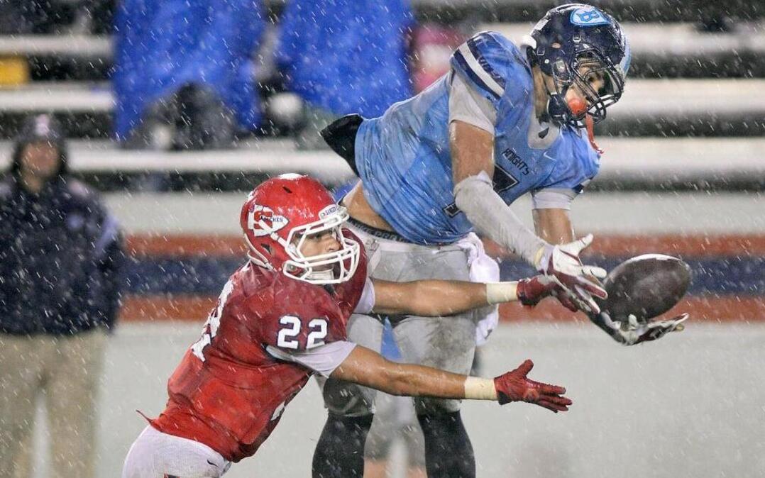 Sanger High’s Miguel Garcia, left, defends a pass thrown to Bullard’s Cavughn Stewart. Garcia, a Bee Player of the Year candidate as a linebacker and fullback, helps lead the 12-0 Apaches into Friday’s Central Section Division II final against visiting Ridgeview.