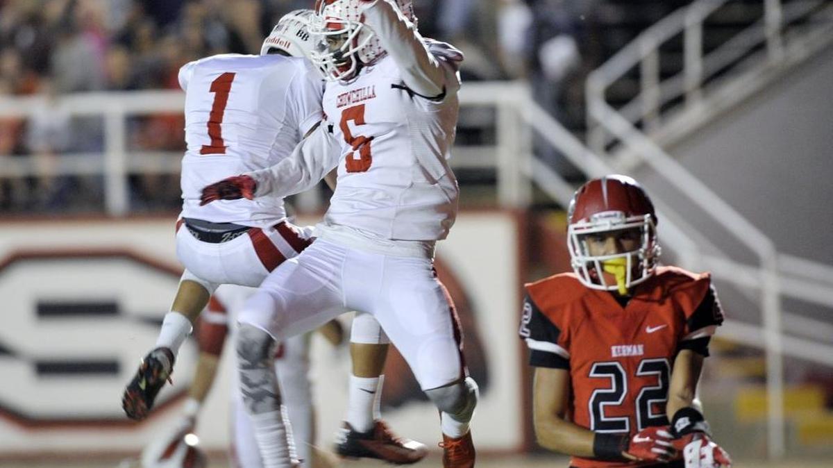 
Chowchilla’s Bernardo Bustillos, left, celebrates Anthony Stewart’s touchdown with Stewart, center, in the first quarter while Kerman’s Angel Lechuga, right, walks away Friday night, October 9, 2015 in Kerman, Calif.
