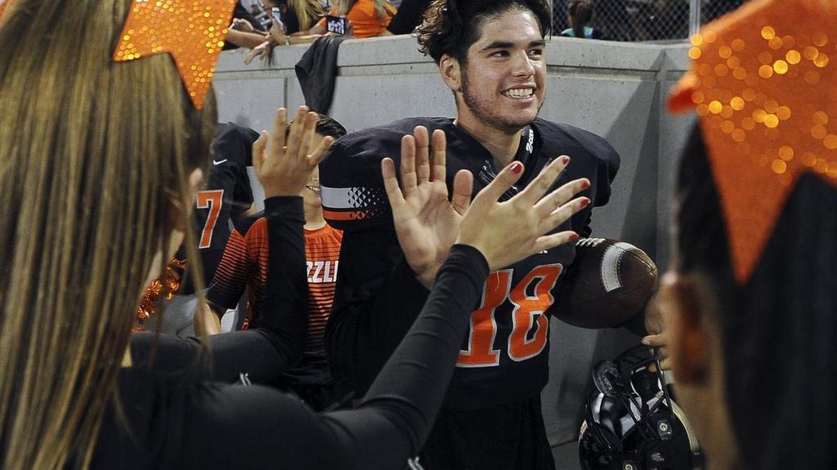 Central sophomore quarterback Trent Tompkins is applauded while entering Koligian Stadium before passing for 272 yards and two touchdowns in the Grizzlies’ 21-17 Tri-River Athletic Conference win over then-No. 1 and unbeaten Clovis on Friday, Oct. 14, 2016.