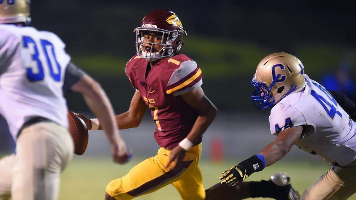 Clovis West’s quarterback David Pierro, center, rolls out under pressure from Clovis High Friday night, Oct. 26, 2018 in Clovis. Clovis West led 24-21 at halftime