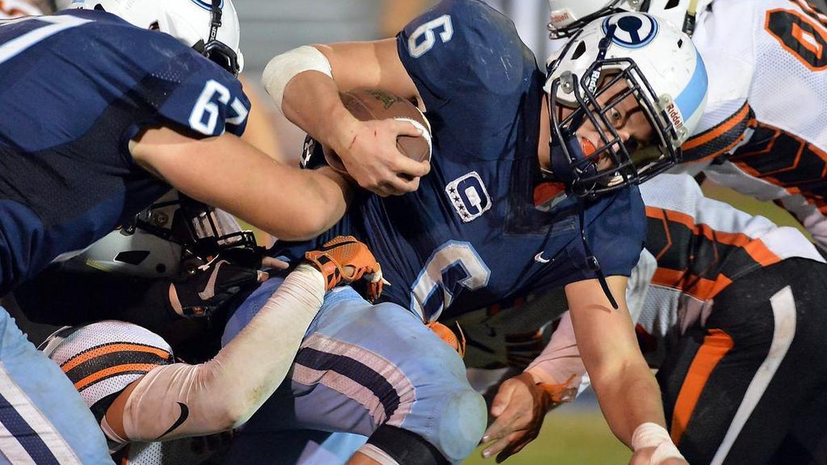 From left, Selma’s Jordan Dominguez, Jason Nicacio, and Paul Moreno tackle Central Valley Christian’s Kolin Stock (6) in a Central Sequoia League game at Central Valley Christian on Friday, Oct. 30, 2015 in Visalia, California.