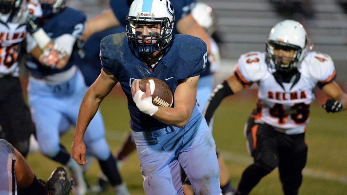 Central Valley Christian High’s Kolin Stock looks for running room against Selma’s defense in the first quarter of a Central Sequoia League game Oct. 31, 2015, in Visalia. Stock rushed for 227 yards and three touchdowns in a 26-24 win that clinched at least a share of the CSL title for the Cavaliers.