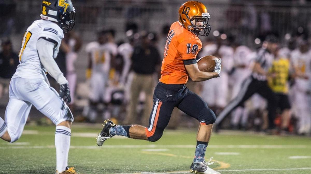 
Merced senior wide receiver Timothee Miranda (18) gains extra yards after a catch against Edison in Friday’s game at Veterans Stadium in Merced. The Bears beat the Tigers 18-6.
