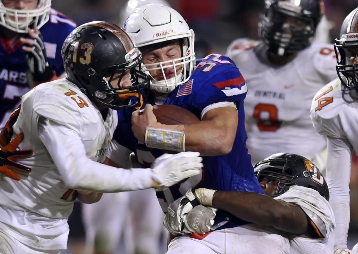 Buchanan High’s Trevor Ervin is tackled by Central’s Tre Walker, right, with an assist from Noah Gonzales on Thursday night, Oct. 5, 2017. Ervin rushed for 210 yards on 16 carries and four touchdowns, but the Central Section No. 2-ranked Bears fell to the No. 1 Grizzlies 28-27.